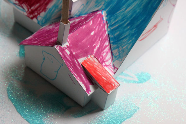 a blue glitter snow paper marker house