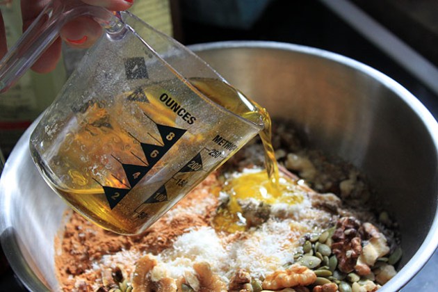 pour olive oil in granola miz bowl