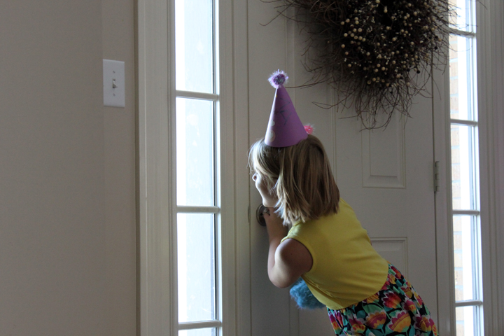 a a waiting for party guests at the door